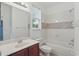 Well-lit bathroom featuring a tiled shower and a window at 5525 Oakworth Pl, Sanford, FL 32773