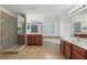 Bathroom featuring tile floors, vanity sinks, glass shower, and a soaking tub at 5525 Oakworth Pl, Sanford, FL 32773