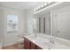 Bathroom featuring double vanity with a marble countertop and a shower with mosaic tile at 5525 Oakworth Pl, Sanford, FL 32773