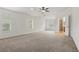 Carpeted bedroom with windows providing natural light and access to ensuite bath at 5525 Oakworth Pl, Sanford, FL 32773