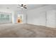 Spacious bedroom featuring plush carpet, ceiling fan, and ensuite bathroom access at 5525 Oakworth Pl, Sanford, FL 32773