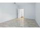 Open view of an empty room with hard flooring and white walls with open door at 5525 Oakworth Pl, Sanford, FL 32773
