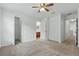 Spacious bedroom with neutral carpet, ceiling fan, and multiple doorways at 5525 Oakworth Pl, Sanford, FL 32773