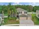 Inviting two-story home featuring a stone facade, three-car garage, and mature landscaping in a suburban setting at 5525 Oakworth Pl, Sanford, FL 32773