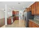 Open kitchen with granite counters, stainless appliances, tile flooring and convenient layout at 5525 Oakworth Pl, Sanford, FL 32773