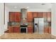 Modern kitchen with stainless steel appliances, granite countertops, and a decorative tile backsplash at 5525 Oakworth Pl, Sanford, FL 32773