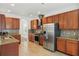 Spacious kitchen equipped with stainless steel appliances, granite counters, and tile backsplash at 5525 Oakworth Pl, Sanford, FL 32773