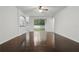 Bright living room featuring hardwood flooring, a ceiling fan, and sliding doors to the backyard at 5525 Oakworth Pl, Sanford, FL 32773