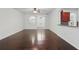 Well-lit living room with hardwood flooring and views into the kitchen at 5525 Oakworth Pl, Sanford, FL 32773