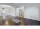 Bright living room showcasing hardwood floors, white walls, and an open layout connecting to the dining area at 5525 Oakworth Pl, Sanford, FL 32773