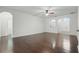 Spacious living room boasting hardwood flooring, ceiling fan, and arched doorways leading to other rooms at 5525 Oakworth Pl, Sanford, FL 32773