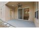 Covered patio area with ceiling fan and view into the home's interior at 5525 Oakworth Pl, Sanford, FL 32773