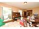 Sunlit dining area featuring tiled floors, large windows, and furniture at 6105 Lost Tree Court, Orlando, FL 32808