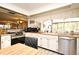 Well-lit kitchen with stainless steel appliances, wood countertops, and a seamless flow to the dining area at 6105 Lost Tree Court, Orlando, FL 32808