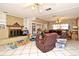 Spacious living room with brick fireplace, tile flooring, and comfortable seating at 6105 Lost Tree Court, Orlando, FL 32808