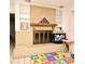 Living room with brick fireplace, white built-in shelves, and tile flooring at 6105 Lost Tree Court, Orlando, FL 32808
