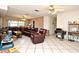 Bright living room featuring tile floors, large seating area, and natural light at 6105 Lost Tree Court, Orlando, FL 32808