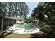 Backyard pool and patio area surrounded by lush trees and greenery at 6105 Lost Tree Court, Orlando, FL 32808