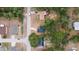 Aerial view of homes nestled among lush trees in a suburban neighborhood with established lawns at 6345 Hatcher Rd, Lakeland, FL 33811