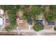 Home nestled amongst lush trees in a suburban neighborhood with established lawns and serene landscaping at 6345 Hatcher Rd, Lakeland, FL 33811