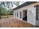Wooden deck with open doors leading into a home, ideal for seamless indoor-outdoor living at 6345 Hatcher Rd, Lakeland, FL 33811