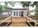 Inviting back porch with wooden deck and steps, perfect for outdoor relaxation and entertaining at 6345 Hatcher Rd, Lakeland, FL 33811