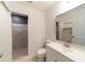 Bright bathroom featuring tiled shower, hexagon floor and vanity with sink, all in neutral tones at 6345 Hatcher Rd, Lakeland, FL 33811