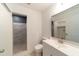 Bright bathroom featuring a single sink vanity and tiled shower at 6345 Hatcher Rd, Lakeland, FL 33811