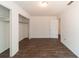 Bedroom featuring wood-look tile flooring, two closets, and neutral walls at 6345 Hatcher Rd, Lakeland, FL 33811