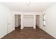 Bedroom with a closet, wood-look tile flooring, and natural lighting at 6345 Hatcher Rd, Lakeland, FL 33811