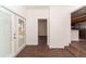 Bright entryway with wood-look tile flooring leading to kitchen and outdoor access at 6345 Hatcher Rd, Lakeland, FL 33811