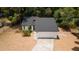 Charming home features a two-car garage, fresh exterior paint, a well maintained lawn, and lush landscaping at 6345 Hatcher Rd, Lakeland, FL 33811