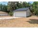 Charming single-story home featuring a white exterior, a two-car garage, and well-maintained landscaping at 6345 Hatcher Rd, Lakeland, FL 33811