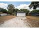 Charming single-story home featuring a white exterior, a two-car garage, and well-maintained landscaping at 6345 Hatcher Rd, Lakeland, FL 33811