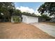 Charming single-story home featuring a white exterior, a two-car garage, and well-maintained landscaping at 6345 Hatcher Rd, Lakeland, FL 33811