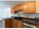 Kitchen showing wood cabinets, dark countertops, and stainless steel appliances at 6345 Hatcher Rd, Lakeland, FL 33811