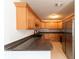 Kitchen featuring wood cabinets, dark countertops, and stainless steel appliances at 6345 Hatcher Rd, Lakeland, FL 33811