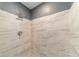 Shower featuring gray tiling, rainfall showerhead, and updated fixtures at 6345 Hatcher Rd, Lakeland, FL 33811