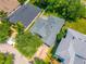 Aerial view of a home with a gray roof and brick paver driveway, as well as a back yard patio at 6542 Lake Pembroke Pl, Orlando, FL 32829