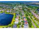 Aerial view of the neighborhood, lake, and subject home with red location pin at 6542 Lake Pembroke Pl, Orlando, FL 32829