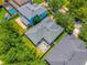 Aerial view of house with fenced backyard featuring paved patio and seating, as well as a gray roof at 6542 Lake Pembroke Pl, Orlando, FL 32829
