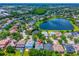 Aerial view of neighborhood, lake, and subject home with red location marker, as well as a back patio at 6542 Lake Pembroke Pl, Orlando, FL 32829