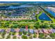 Expansive aerial view of the community showcasing the neighborhood, lakes, and lush landscaping at 6542 Lake Pembroke Pl, Orlando, FL 32829