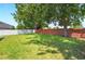 Expansive backyard with a privacy fence and mature trees, providing ample space for outdoor activities at 6542 Lake Pembroke Pl, Orlando, FL 32829