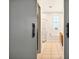 Hall bathroom featuring tile floors, neutral paint, sliding barn door and shower over tub at 6542 Lake Pembroke Pl, Orlando, FL 32829