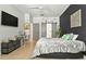 Modern bedroom with tile floors, dark accent wall, barn door entry to en-suite bath, and a ceiling fan at 6542 Lake Pembroke Pl, Orlando, FL 32829