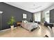 Comfortable bedroom featuring tile floors, dark accent wall, ceiling fan, and lots of natural light at 6542 Lake Pembroke Pl, Orlando, FL 32829