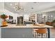 Bright, open kitchen boasts an island with bar seating, modern lighting, and stainless steel appliances at 6542 Lake Pembroke Pl, Orlando, FL 32829