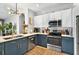 Well-designed kitchen with two-toned cabinetry, stainless steel appliances, stylish fixtures, and ample counter space at 6542 Lake Pembroke Pl, Orlando, FL 32829