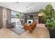 Comfortable living room with ceiling fan, tile flooring, and view of the outdoor backyard and patio at 6542 Lake Pembroke Pl, Orlando, FL 32829